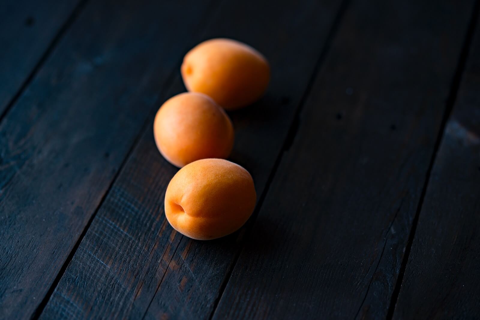 three fruits on wooden surface